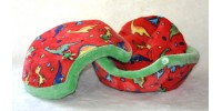 Coussin Coquille, dinosaures colorés sur fond rouge (petit)